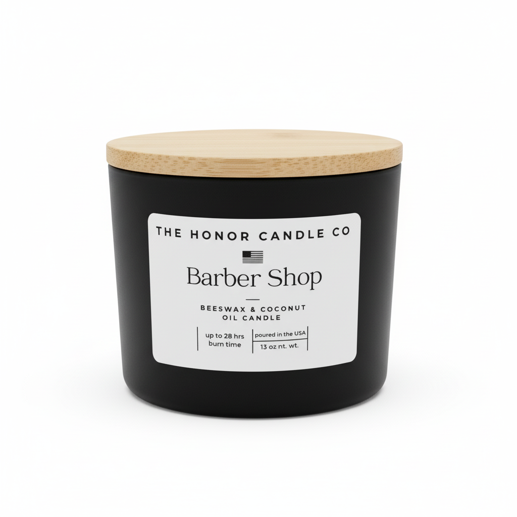 Black candle with wooden lid from The Honor Candle Co, featuring a white label with the scent name.