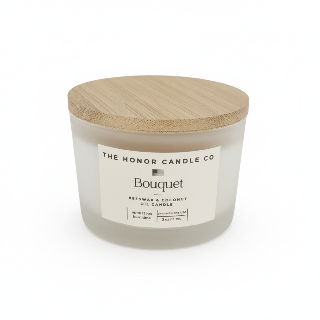 White bouquet candle by The Honor Candle Co with a wooden lid on a white background.