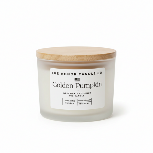 Golden Pumpkin candle by The Honor Candle Co, featuring a wooden lid and white label.
