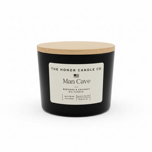 Black Man Cave beeswax and coconut oil candle by The Honor Candle Co with a wooden lid.