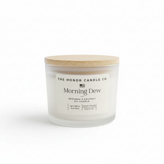 Beeswax and coconut oil candle by The Honor Candle Co, with a wooden lid and a frosted glass jar.
